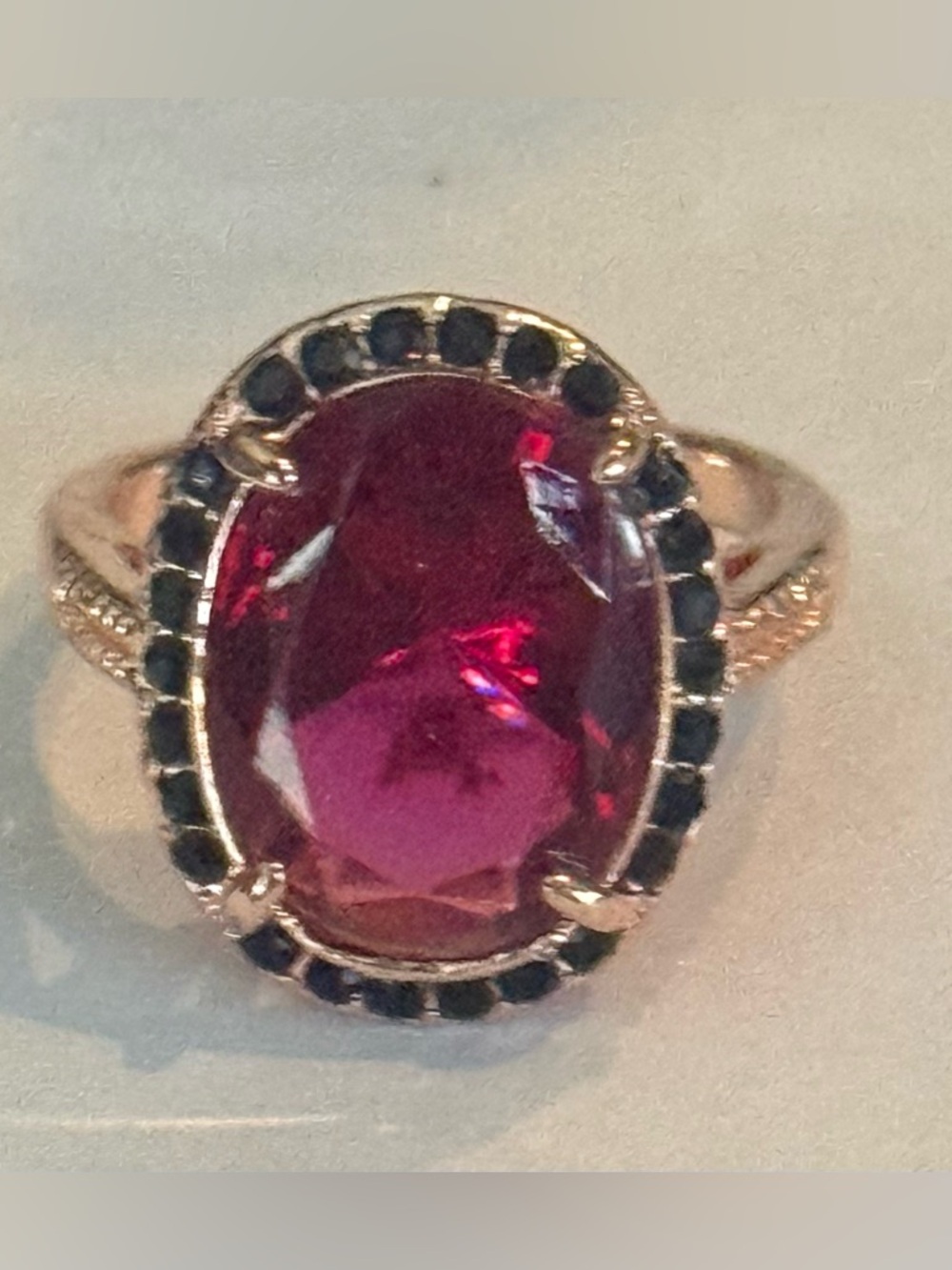 Rose Gold-Tone Ring with Pink Oval Center Stone and Black Accent Halo & Zircon